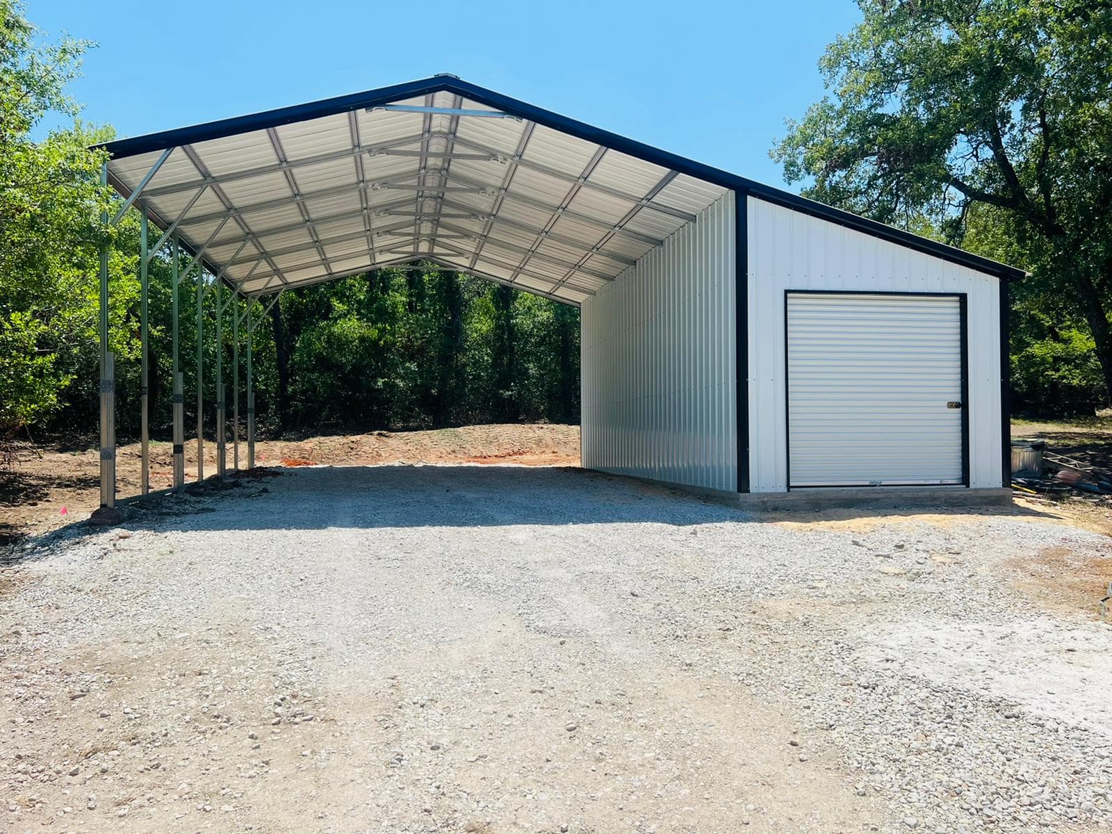 Metal carport with an enclosed storage room built onto one end