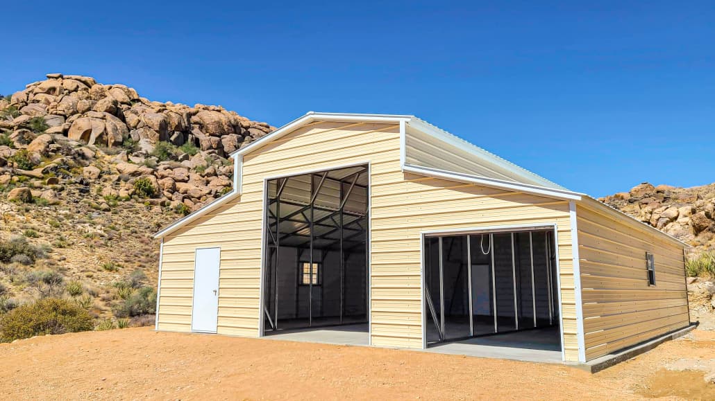A steel barn with a vertical roof and wainscot trim in a rural field